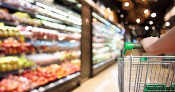 Grocery store cart in fresh aisle