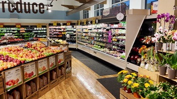 Produce section of a grocery store that is very clean and neat.