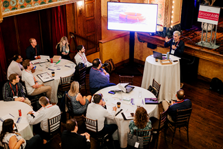 Scene from GroceryLab event with participants and speaker with screen