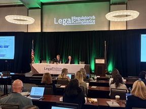 Two panelists on stage at the Legal Conference