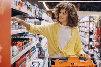 Woman shopping in personal care aisle at grocery store