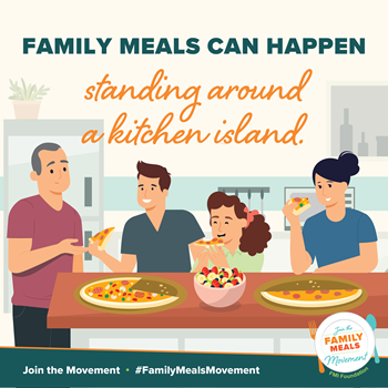 "Family Meals can happen standing around a kitchen island": family is depicted sharing a salad and pizza on the kitchen counter