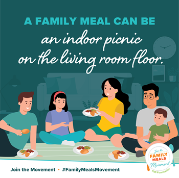 "A Family Meal Can Be an Indoor Picnic on the Living Room Floor": Blended or chosen family is depicted with multiple age ranges; all are sharing a healthy meal with a blanket spread for a living room picnic