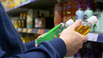 Customer looking at shampoo in grocery store