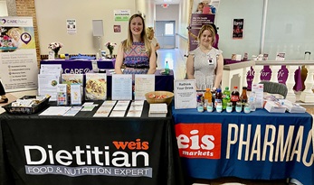 Booth set ups at a community event featuring dietitian and pharmacy services at a grocery store